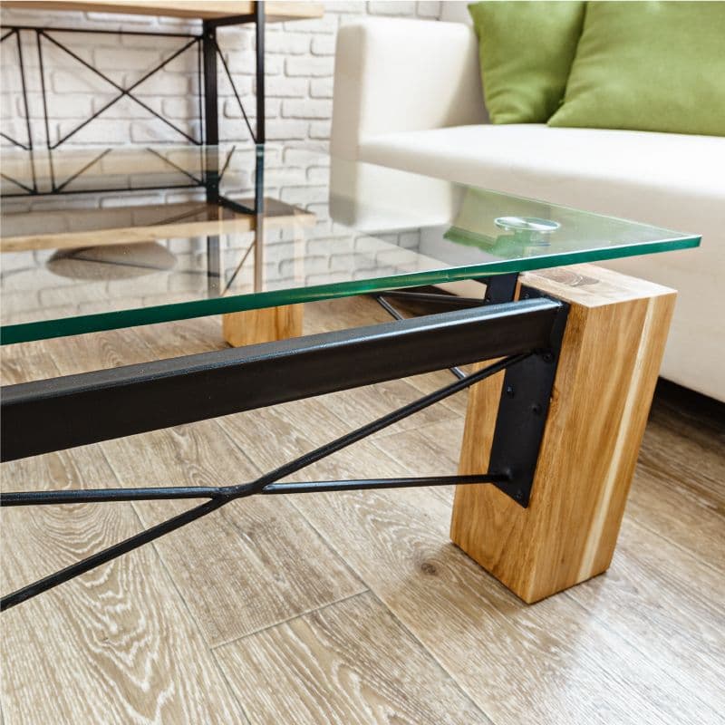 Modern coffee table with tempered glass top and wooden base, showcasing custom glass design suitable for shower doors, table tops, and mirrors.